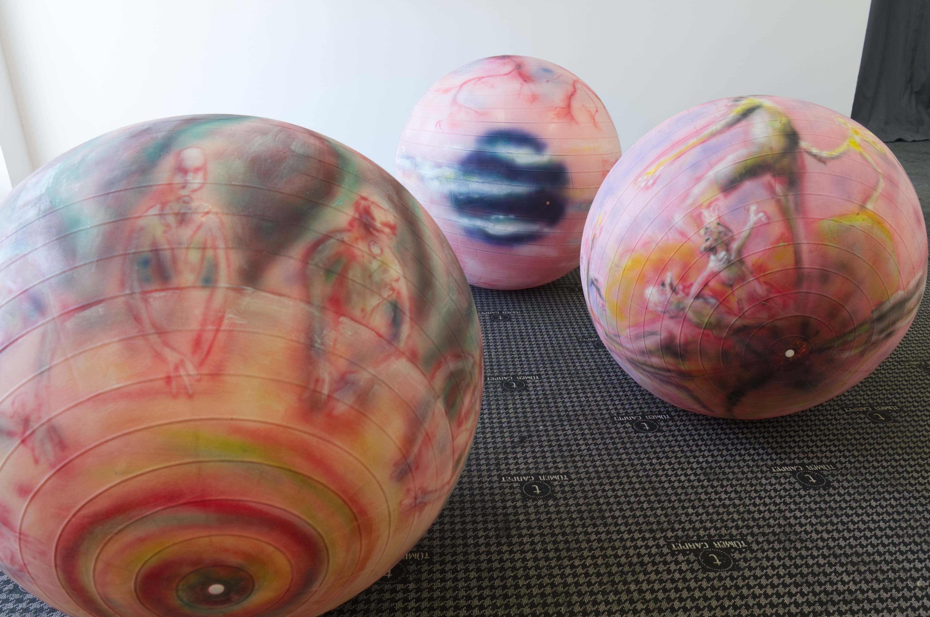 Three painted rose pilates balls