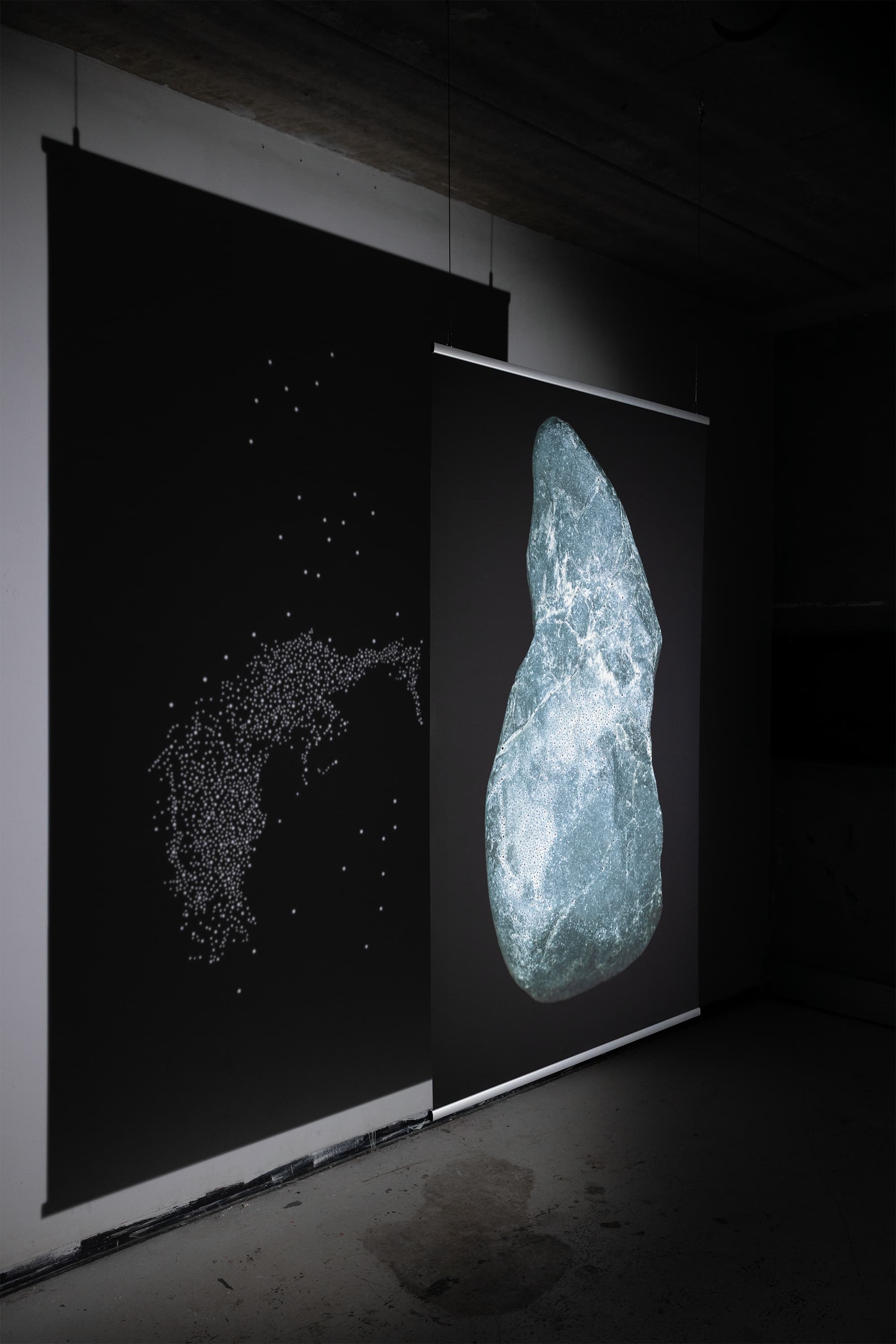 The image is a high-resolution digital scan of the surface of a stone collected along the Dora River in Turin, Italy. Printed at a large scale, it amplifies the visual experience of the traces emerging from the rock. These figures are considered acheiropoietic images—forms not made by human hands.  The research draws on the practice of reading stones as a form of divination. The images revealed on the rock’s surface guide the divinatory act, activating the imagination and perceptual sensitivity of the seer.