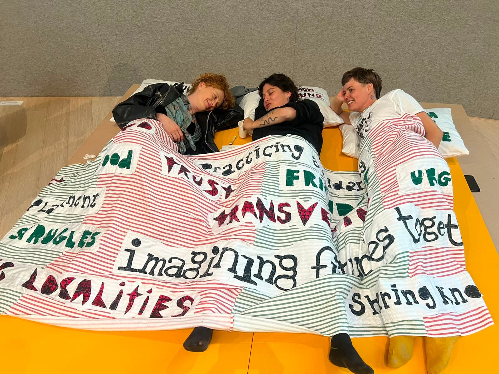 Audience sleeping in the "How to Organise" zone/area where the Blanket place