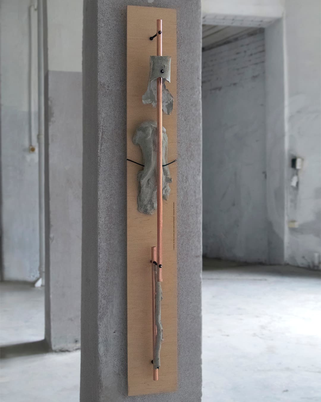 One of the sculptures from the series Displaced, with concrete castings of apple tree roots and copper elements.