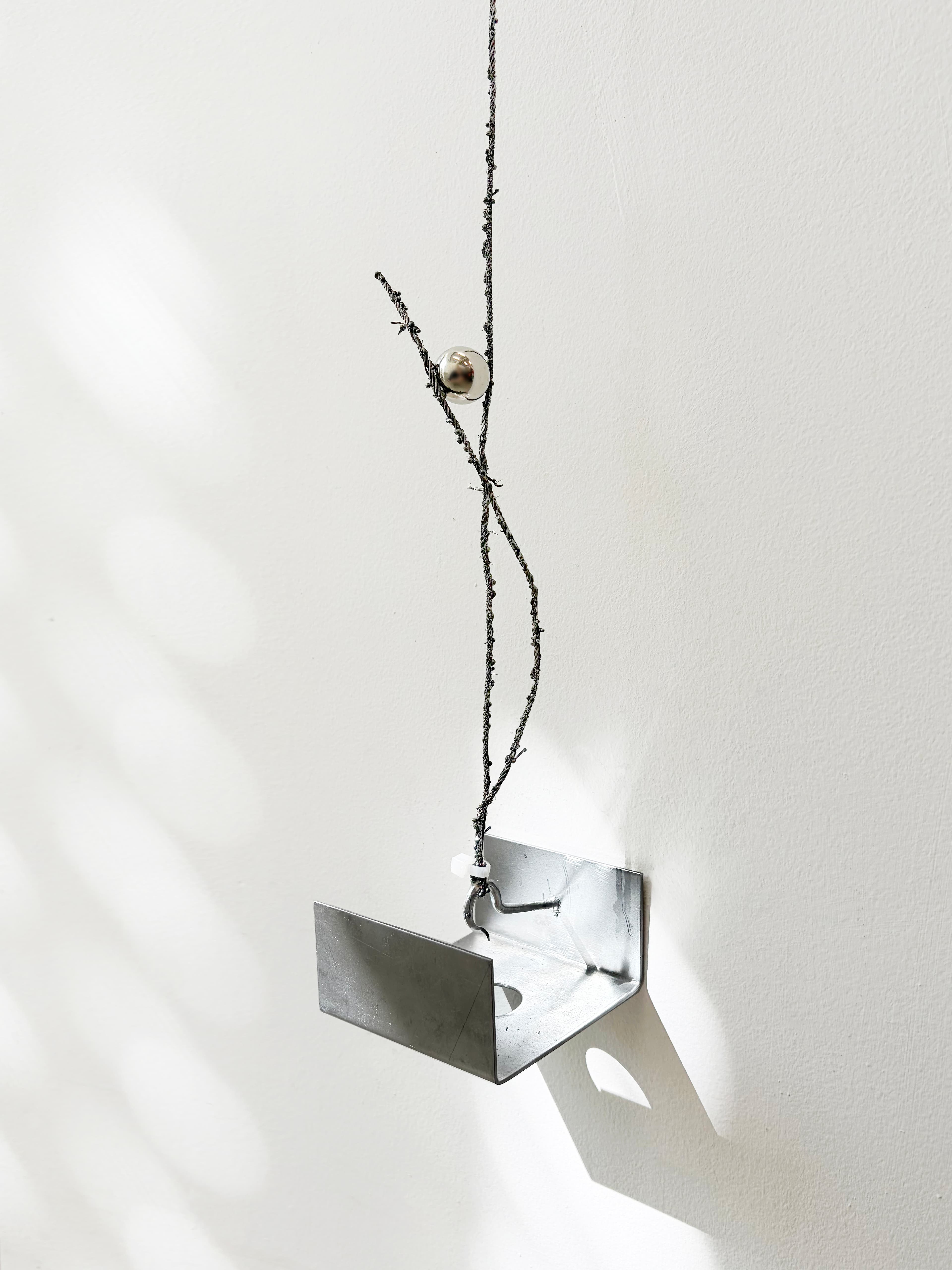 A fragment of a steel cable sculpture from the series Seam.